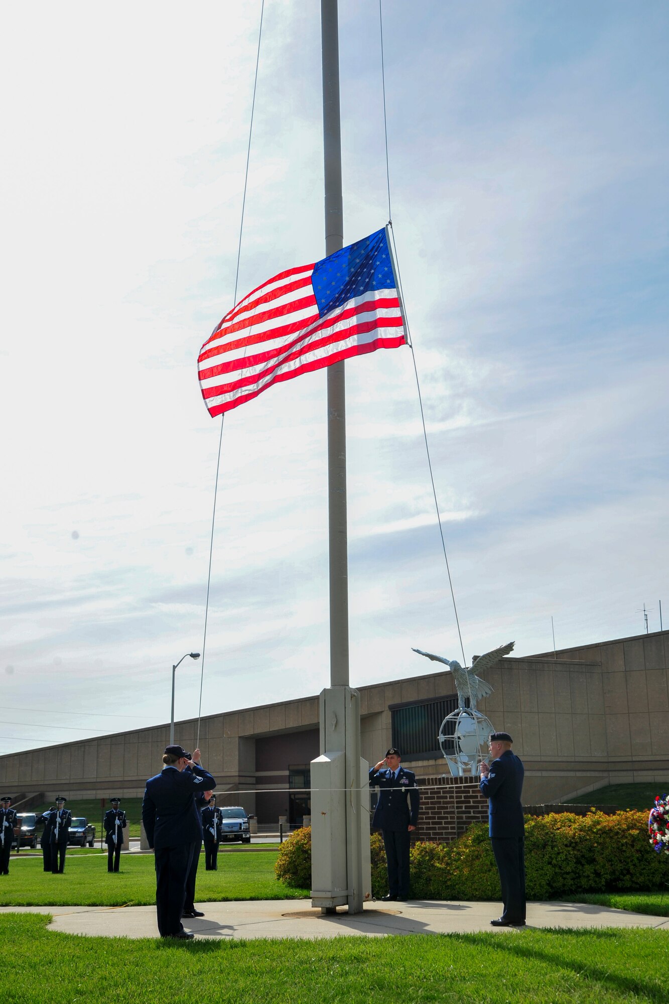 A 436th Security Forces Squadron flag-detail  lowers the U.S. Flag during a retreat ceremony May 20, 2016, outside of the 436th Airlift Wing headquarters building on Dover Air Force Base, Del. Various law enforcement agencies from the state gathered with members of the 436th SFS to honor and remember fallen police officers and their families during the retreat ceremony. (U.S. Air Force photo/Senior Airman William Johnson)