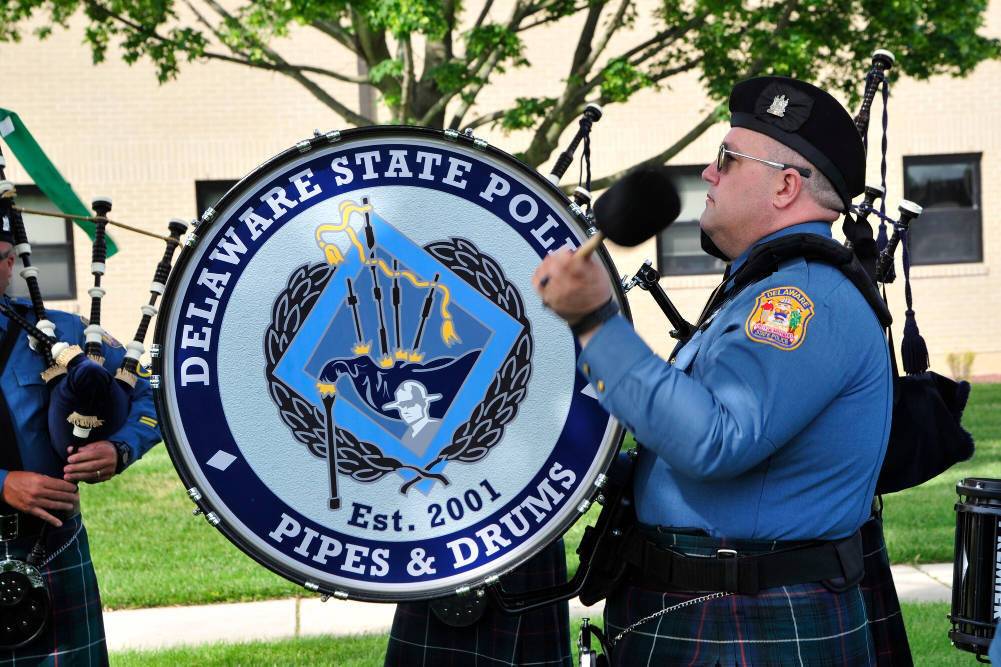 A member of the Delaware State Police Pipes & Drums plays his drum during a retreat ceremony commemorating fallen military and civilian law enforcement officers May 20, 2016, outside of the 436th Airlift Wing headquarters building on Dover Air Force Base, Del. National Police Week culminated with the observance of the retreat ceremony. (U.S. Air Force photo/Senior Airman William Johnson) 