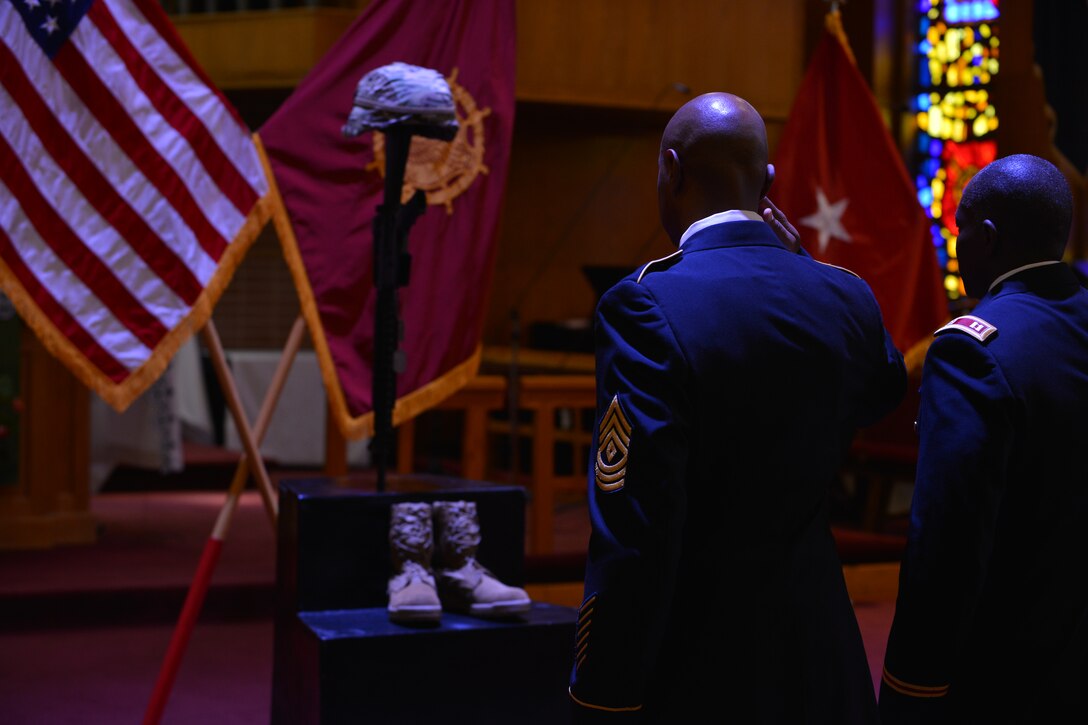 U.S. Army Soldiers salute the battlefield cross during the U.S. Army Transportation Corps Wreath Laying Ceremony at Fort Eustis, Va., May 24, 2016.  Ceremony attendees including Service members and Gold Star families were afforded the opportunity to pay their respects to the fallen at the cross. (U.S. Air Force photo by Staff Sgt. Natasha Stannard)