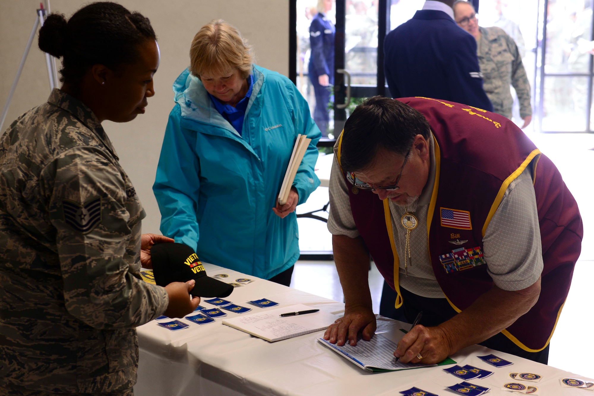 Retired U.S. Air Force Capt. Bill Robinson, former Prisoner of War, signs in at a Vietnam War Commemoration ceremony at Langley Air Force Base, Va., May 18, 2016. Robinson was the guest speaker for the event, detailing his seven and a half years spent as a prisoner of war. (U.S. Air Force photo by Staff Sgt. Ciara Gosier)