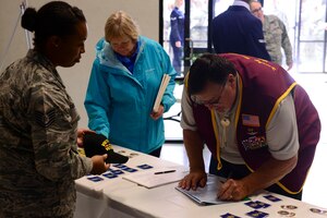 Retired U.S. Air Force Capt. Bill Robinson, former Prisoner of War, signs in at a Vietnam War Commemoration ceremony at Langley Air Force Base, Va., May 18, 2016. Robinson was the guest speaker for the event, detailing his seven and a half years spent as a prisoner of war. (U.S. Air Force photo by Staff Sgt. Ciara Gosier)