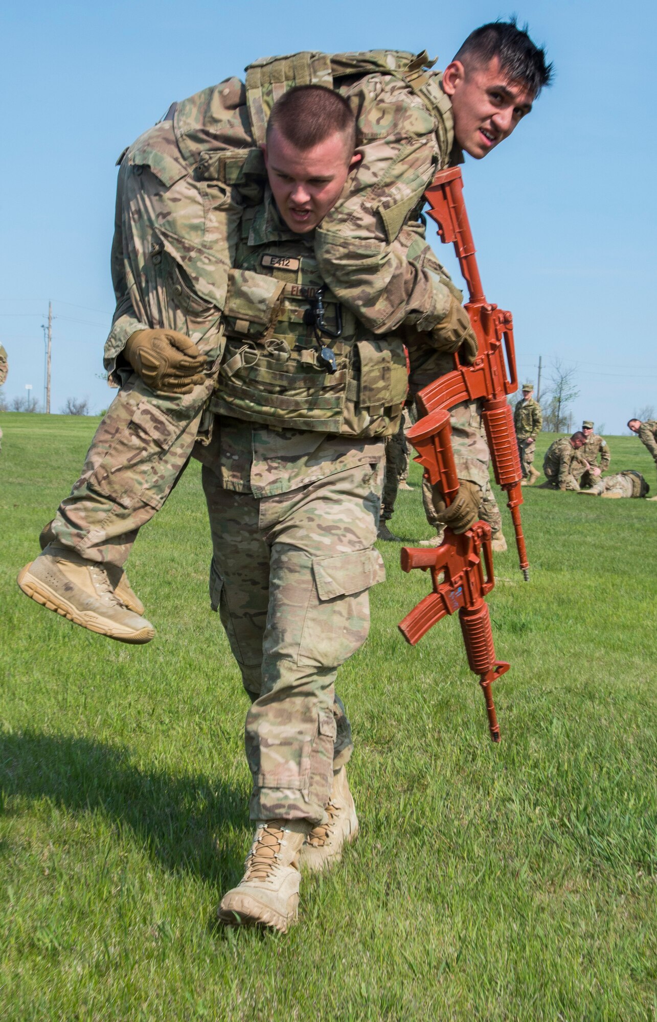 Airman Nicholas Elliott, 91st Missile Security Forces Squadron member, buddy carries a teammate during the top cop challenge at Minot Air Force Base, N.D., May 18, 2016. During the challenge Airmen were tested physically and mentally as the raced to see who finished first. (U.S. Air Force photo/Airman 1st Class Christian Sullivan)