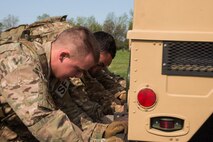 Security Forces Airmen push a Humvee during the top cop challenge at Minot Air Force Base, N.D., May 18, 2016. The top cop challenge was one of many events held in honor of police week at Minot. (U.S. Air Force photo/Airman 1st Class Christian Sullivan)