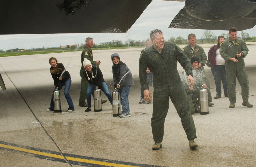 Lt. Col. Jason Karren, 5th Bomb Wing chief of wing inspections, is sprayed with water by his children after his final B-52 flight at Minot Air Force Base, N.D., May 12, 2016. With his retirement approaching, Karren’s family and friends celebrated his last flight as an Air Force pilot. (U.S. Air Force photo/Senior Airman Apryl Hall)