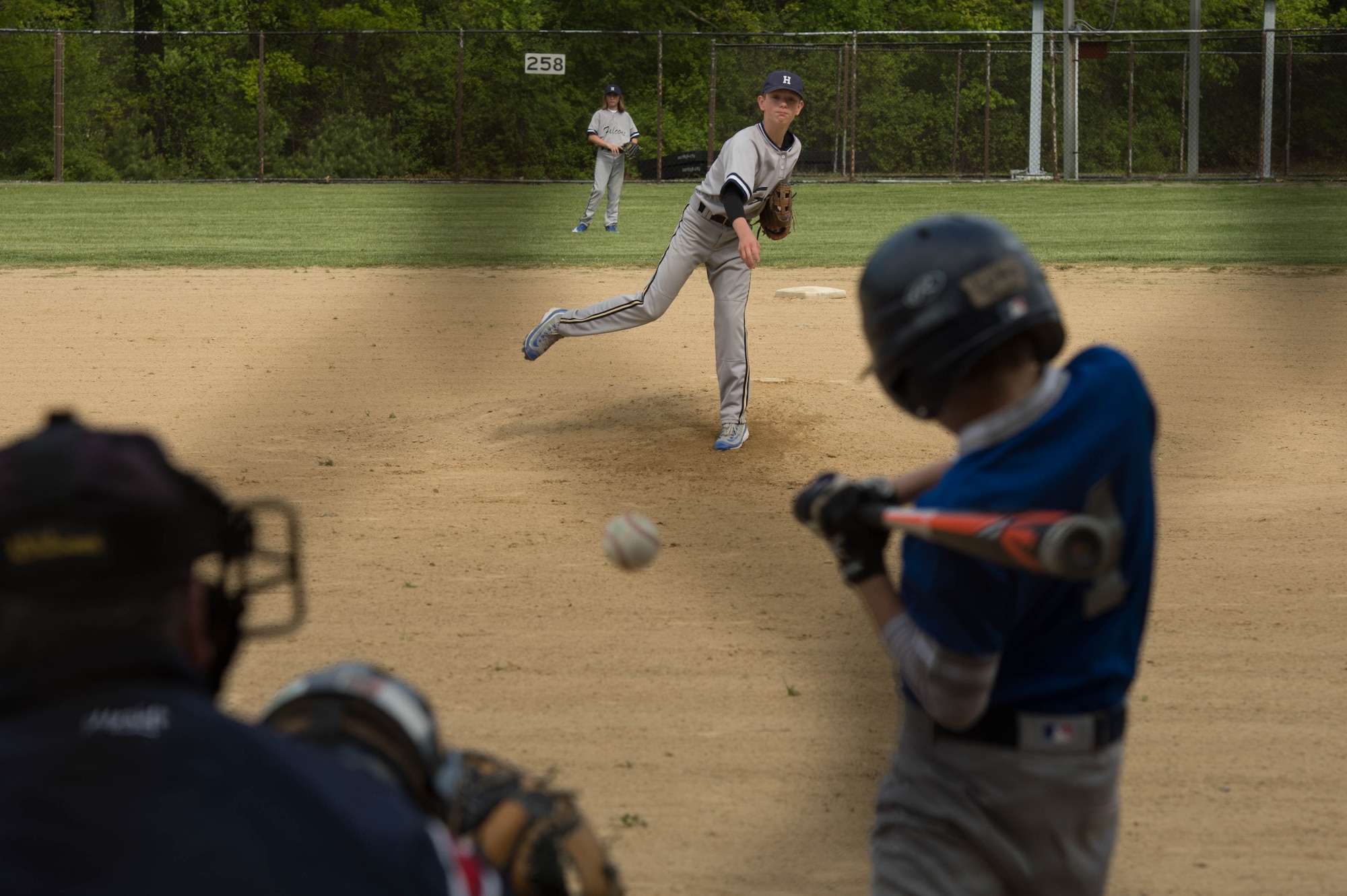 Jared Whitby, an eighth grade member of the Hansom Middle School Falcons boy’s baseball team, throws a pitch to a Lexington Clarke Middle School hitter during the team’s home game May 19. Whitby no-hit Lexington during the 6 to 1 Falcon's win. (U.S. Air Force photo by Jerry Saslav)