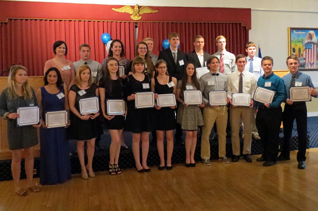 Students pose for a group photo following the 55th annual Hanscom Spouses Club Scholarship Awards Night at the Minuteman Commons May 11. HSC awarded $43,000 to 17 high school graduates and two spouses at the event. (Courtesy photo) 