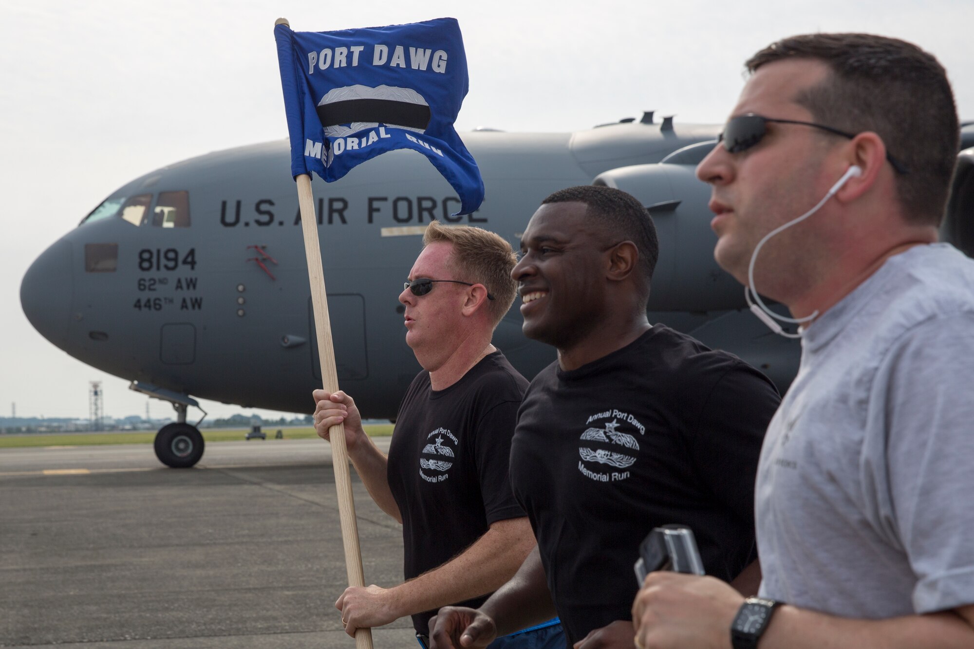 Col. Dale Landis, left, 515th Air Mobility Operations Group commander, holds the guidon during the Port Dawg Memorial 5K Run at Yokota Air Base, Japan, May 20, 2016. The 730th Air Mobility Squadron hosted the annual memorial run for the fallen Airmen in the air transportation career field from the past. (U.S. Air Force photo by Yasuo Osakabe/Released)    