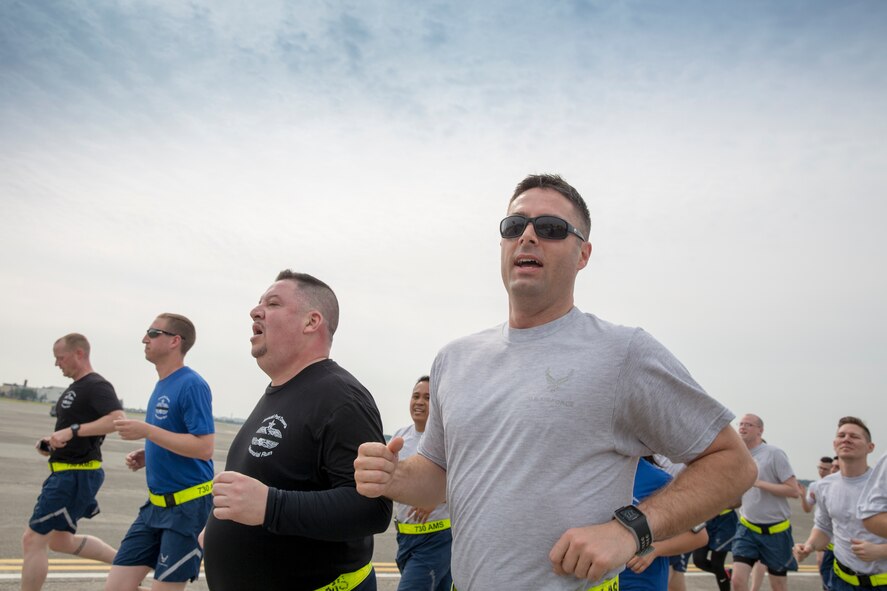 Lt. Col. Bert Adams, center, 730th Air Mobility Squadron commander, runs in a formation during the Port Dawg Memorial 5K Run at Yokota Air Base, Japan, May 20, 2016. The 730 AMS hosted the annual memorial run for the fallen Airmen in the air transportation career field from the past. (U.S. Air Force photo by Yasuo Osakabe/Released)    