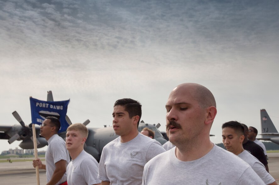 Airmen with the 730th Air Mobility Squadron and 374th Logistics Readiness Squadron run in a formation during the Port Dawg Memorial 5K Run at Yokota Air Base, Japan, May 20, 2016. The 730 AMS hosted the annual memorial run for the fallen Airmen in the air transportation career field from the past. (U.S. Air Force photo by Yasuo Osakabe/Released)  