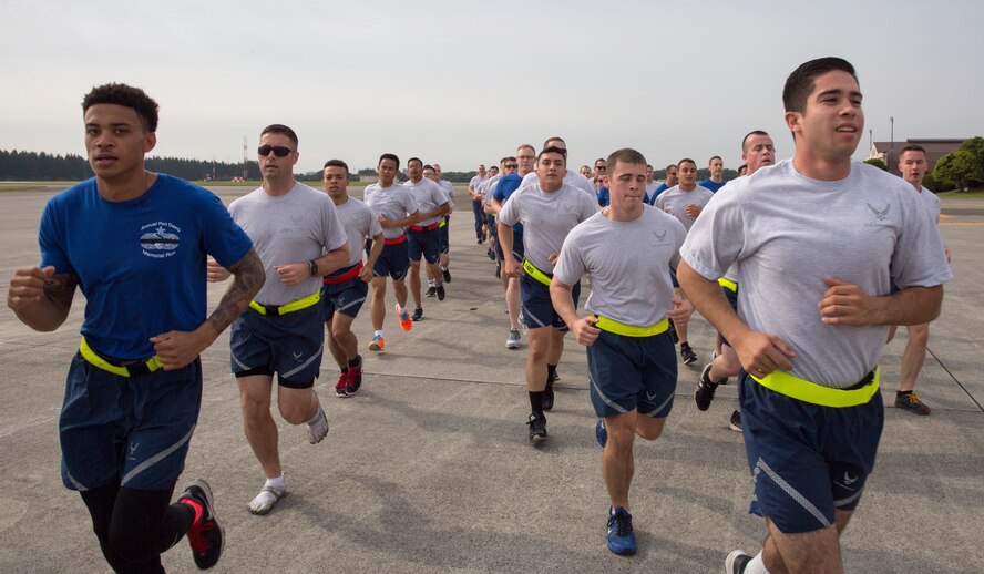 Airmen with the 730th Air Mobility Squadron and 374th Logistics Readiness Squadron run in a formation during the Port Dawg Memorial 5K Run at Yokota Air Base, Japan, May 20, 2016. The 730 AMS hosted the annual memorial run for the fallen Airmen in the air transportation career field from the past. (U.S. Air Force photo by Yasuo Osakabe/Released)  