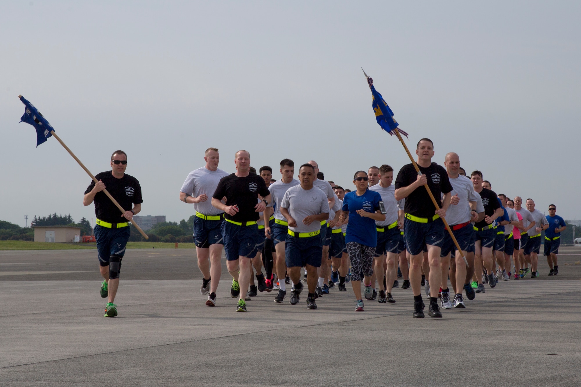 Yokota Airmen from the 515th Air Mobility Operations Group, 730th Air Mobility Squadron, and 374th Logistics Readiness Squadron run in a formation during the Port Dawg Memorial 5K Run at Yokota Air Base, Japan, May 20, 2016. The 730 AMS hosted the annual memorial run for the fallen Airmen in the air transportation career field from the past. (U.S. Air Force photo by Yasuo Osakabe/Released) 
