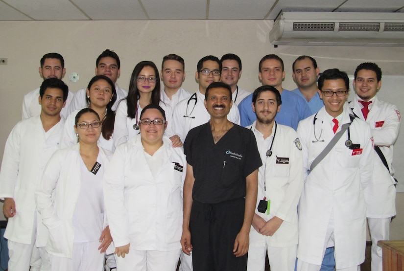 Residents from Hospital Escuela Universitario pose for photo with Col. (Dr.) Kulvinder Bajwa, Joint Task Force-Bravo Medical Element command surgeon, after an advanced laparoscopic surgery presentation at Hospital Escuela Universitario, Tegucigalpa, Honduras, May 13, 2016. Bajwa performed an advanced laparoscopic surgery, participated in a general surgery residency training program, and presented lectures to residents on robotic and laparoscopic surgeries at Hospital Escuela Universitario. (U.S. Army photo by 1st Lt. Jenniffer Rodriguez)