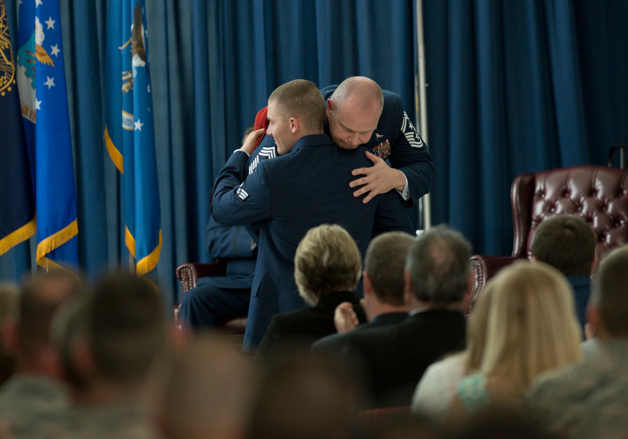 Chief Master Sgt. James W. Hotaling, the 11th command chief master sergeant of the Air National Guard embraces his son, Senior Airman James P. Hotaling after presenting him with his scarlet combat controller beret during his retirement ceremony May 20, 2016, at Joint Base Andrews, Md. Hotaling retired after serving a combined 28 years in the Air Force, Air Force reserve, Air National Guard, and U.S. Coast Guard. (U.S. Air National Guard photo by Master Sgt. Marvin R. Preston/Released)