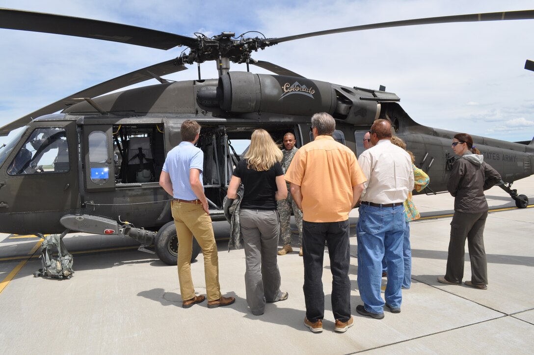 Members from the Trust for Public Land and Great Outdoors Colorado, and key employees from Arapahoe County and City of Aurora took a ride on a Colorado Army National Guard UH-60 Blackhawk helicopter to observe the land surrounding Buckley Air Force Base. Prior to the flight, they met with Maj. Gen. H. Michael Edwards, the Adjutant General of Colorado, and senior leaders from the Colorado National Guard to discuss the ongoing Compatible Use Buffer project at Buckley Air Force Base May 20, 2016. This initiative will provide encroachment protection for the base, ensuring the continued success of the various aviation missions on the installation. (U.S, Air National Guard photo by Capt. Kinder Blacke)