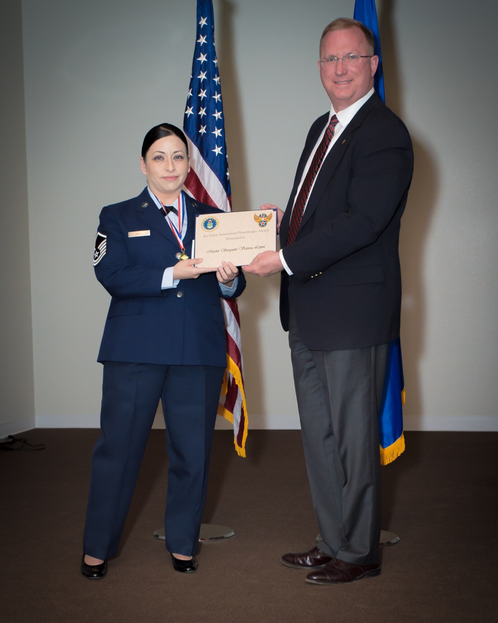 U.S. Air Force Master Sgt. Victoria Lopez with the 153rd Airlift Wing, Wyoming Air National Guard, receives the Pitsenbarger Award, May 15, 2016 at F.E. Warren AFB in Cheyenne, Wyoming. Lopez received the award for her outstanding leadership, teamwork, community service, educational goals and academic achievement. (U.S Air National Guard photo by Master Sgt. Charles Delano/released)