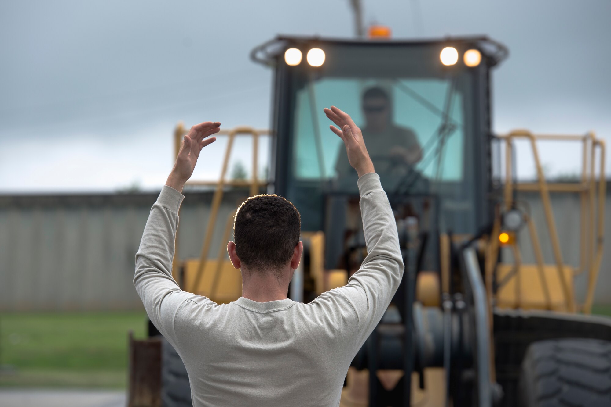 A U.S. Air Force Airmen from the 18th Civil Engineer Squadron directs a forklift during a joint airfield damage repair exercise May 19, 2016 on Kadena Air Base, Japan. The joint ADR exercise allowed new Airmen to gain real world experience in a peacetime environment. (U.S. Air Force phot by Senior Airman Omari Bernard)