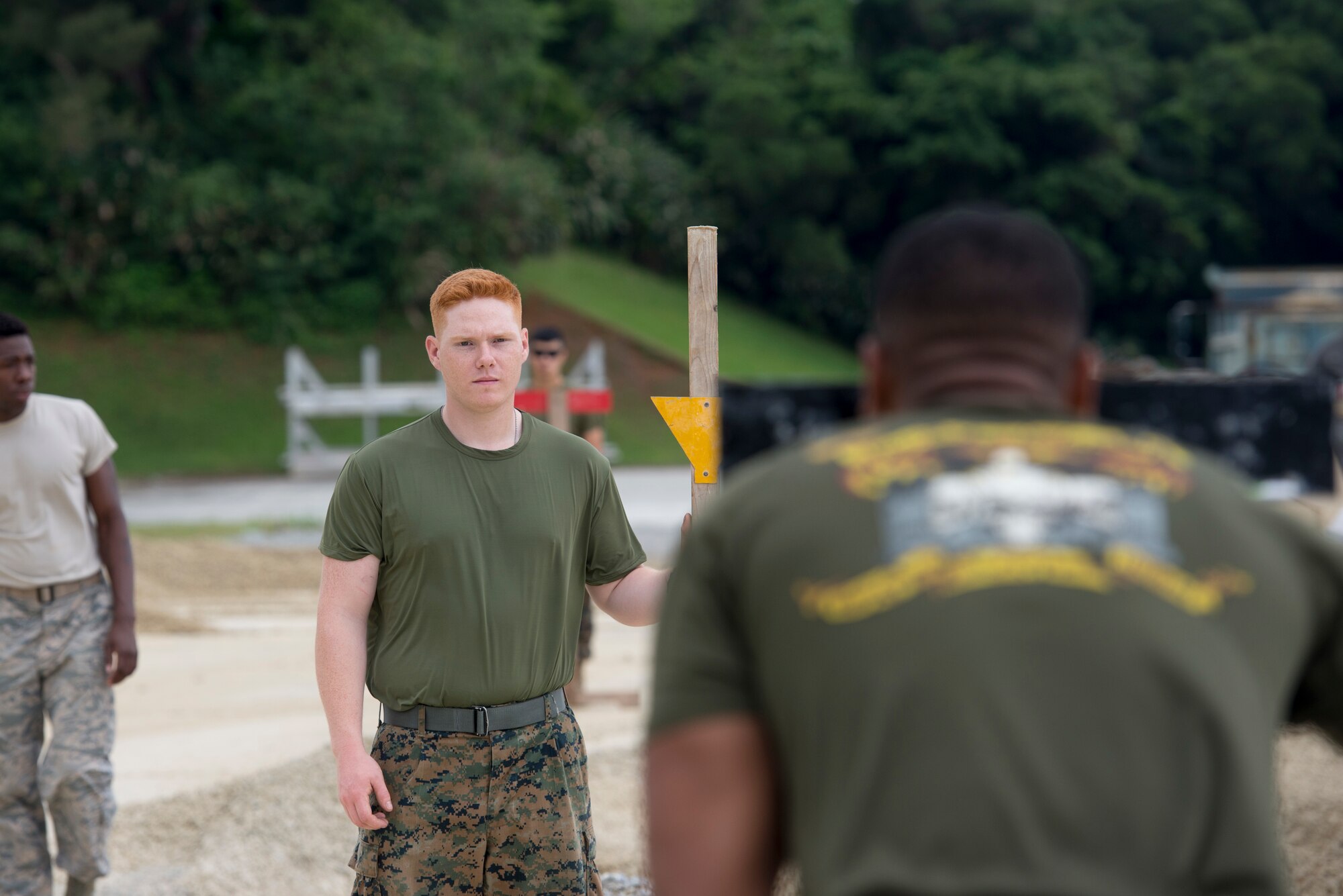 U.S. Marine Corps Lance Cpl. Alec Tweedy, Marine Wing Support Squadron 172 combat engineer, uses a stanchion and rod to measure the ground's evenness for a joint airfield damage repair exercise May 19, 2016 at Kadena Air Base, Japan. Marines from the Marine Wing Support Squadron 172 trained with Airmen from the 18th Civil Engineer Squadron to enhance readiness in a crisis event that would require them to work together. (U.S. Air Force photo by Senior Airman Omari Bernard)