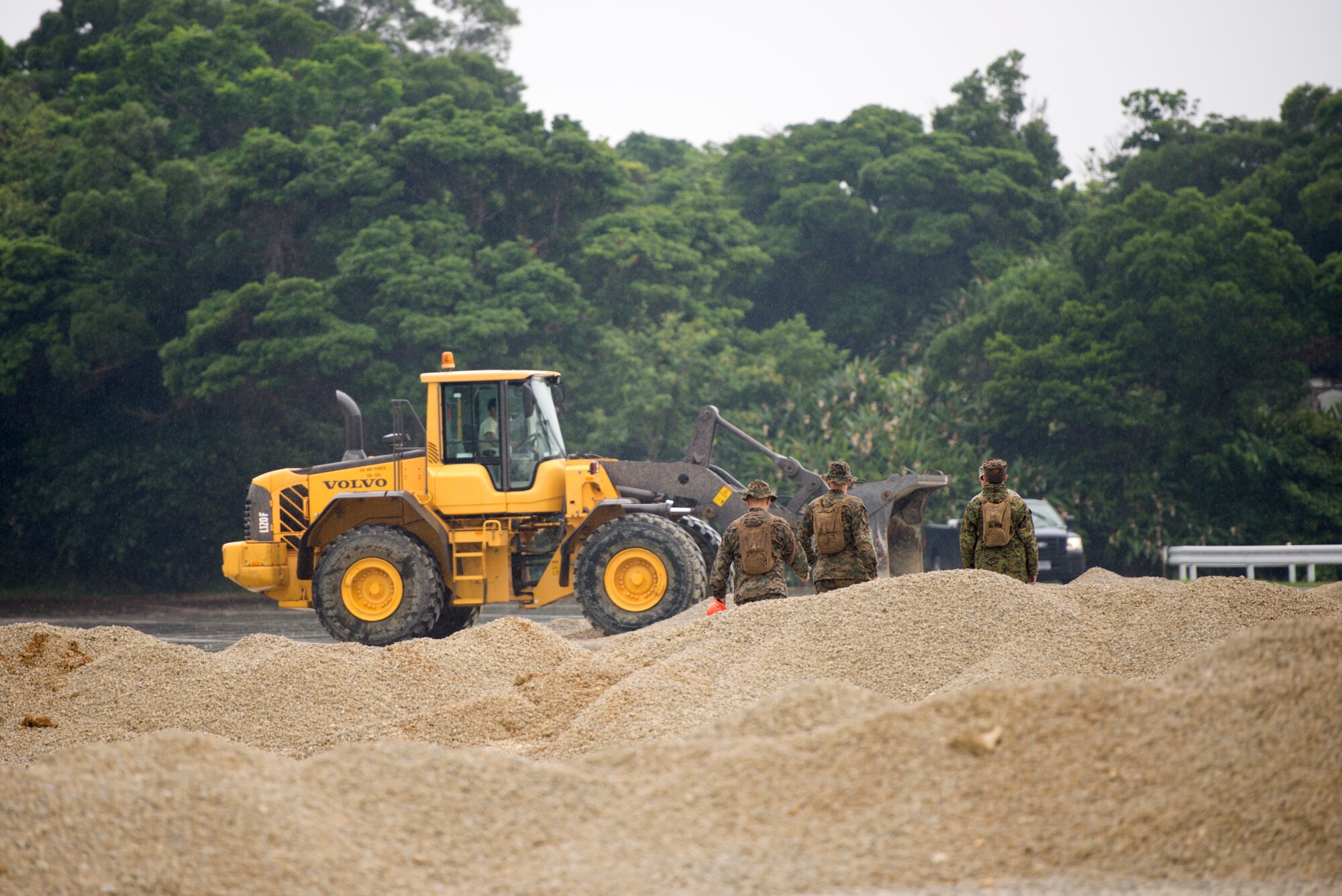 U.S. Marine Corps Marines observe Airmen operating heavy equipment during a two day joint airfield damage repair exercise May 18, 2016 at Kadena Air Base, Japan. Airmen demonstrated the method and technique the U.S. Air Force uses for airfield damage repair the first day of the exercise and the Marines applied those techniques during the second day. (U.S. Air Force photo by Senior Airman Omari Bernard)