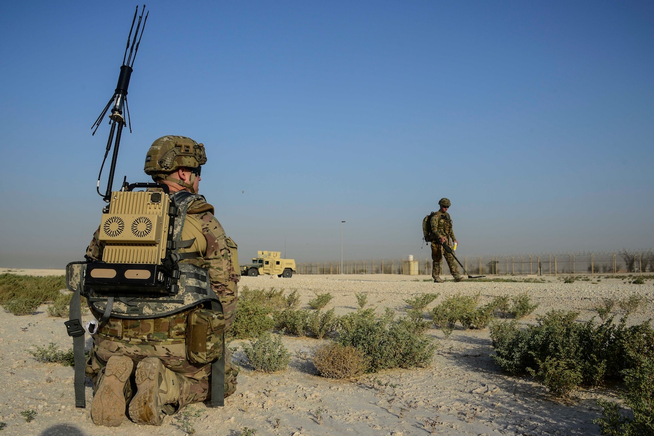 Tech. Sgt. David Dickey, 379th Expeditionary Civil Engineer Squadron explosive ordnance disposal craftsman, stays on standby while Tech. Sgt. Kelly Badger, 379th ECES craftsman, uses a compact metal detector to sweep for improvised explosive devices during a training exercise May 19, 2016, at Al Udeid Air Base, Qatar. The EOD flight conducts training exercises regularly to prepare them for potential incidents. (U.S. Air Force photo/Senior Airman Janelle Patiño/Released)