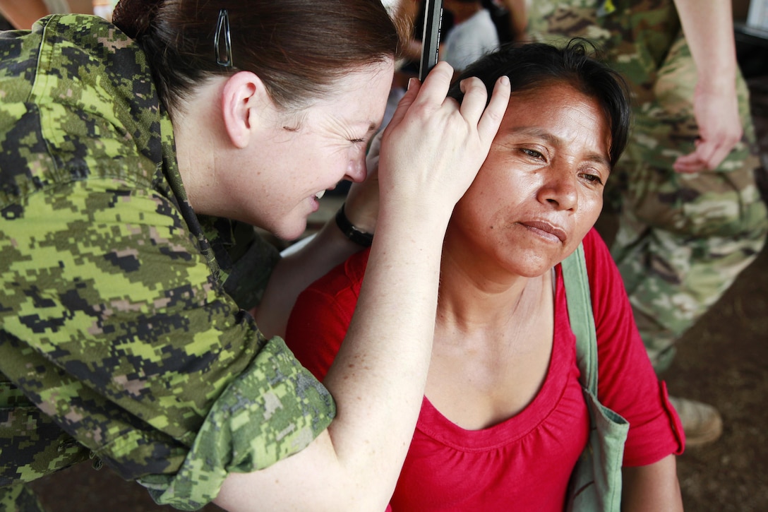 Canadian Navy Lt. Andrea Feist checks a patient's ear for infection during Beyond the Horizon 2016 in San Padro, Guatemala, May 16, 2016. Feist is assigned to the Canadian Forces Health Services Group Headquarters. Army photo by Spc. Kelson Brooks