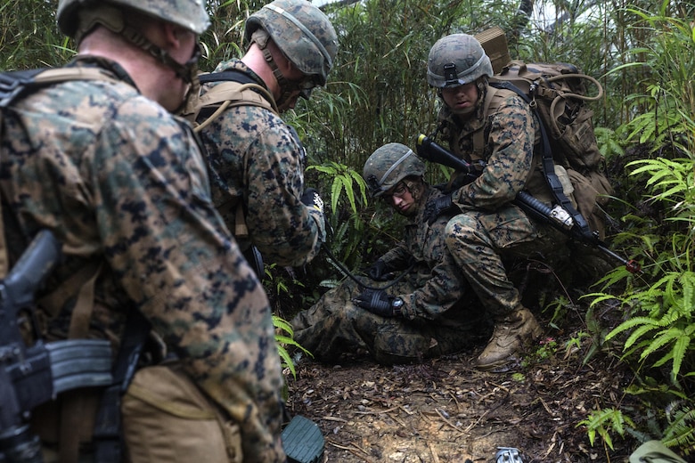 U.S. Marines practice casualty evacuations on May 19, 2016 during the 5-day course at the Jungle Warfare Training Center, Camp Gonsalvas, Okinawa, Japan. The Marines are with 9th Engineer Support Battalion, 3rd Marine Logistics Group, III Marine Expeditionary Force. The course gives Marines the skills to shoot, move and communicate within a jungle environment. (U.S. Marine Corps photo by Lance Cpl. Jessica N. Etheridge/Released)