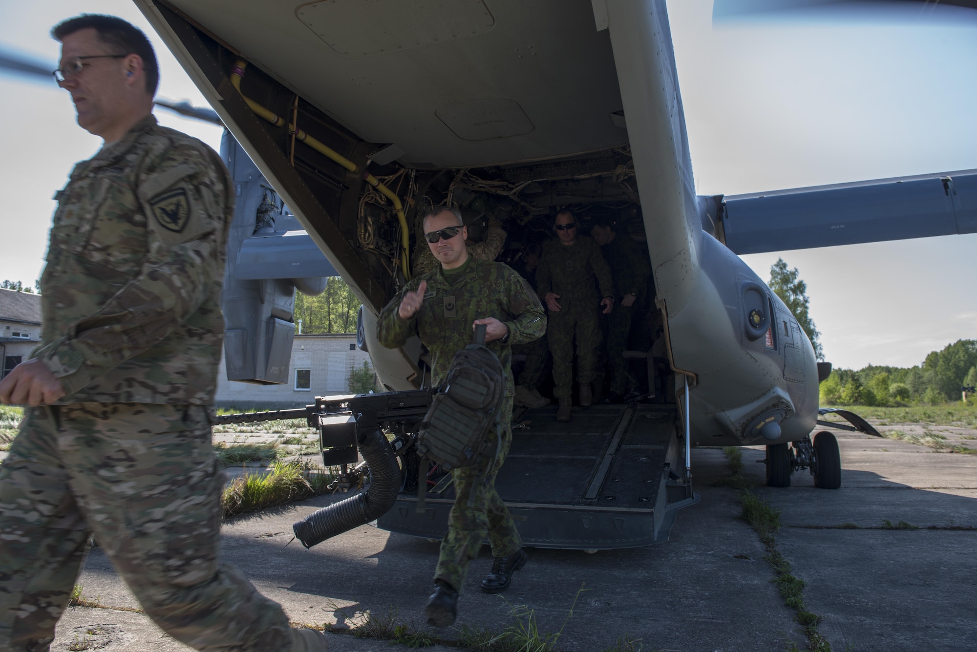 Lithuanian and U.S. military personnel off-load a CV-22 Osprey, from the 352d Special Operations Wing, to take part in the joint, combined military demo for FLAMING SWORD 16 in Pajuostic, Lithuania, May 20, 2016.  CV-22 Ospreys, with maintenance and support personnel, were deployed to Powidz, Poland as part of TROJAN FOOTPRINT 16 and allowed SOCEUR to demonstrate the deployment and employment capabilities of the Very High Readiness Joint Task Force (VJTF). (U.S. Air Force photo by 1st Lt. Chris Sullivan/Released)