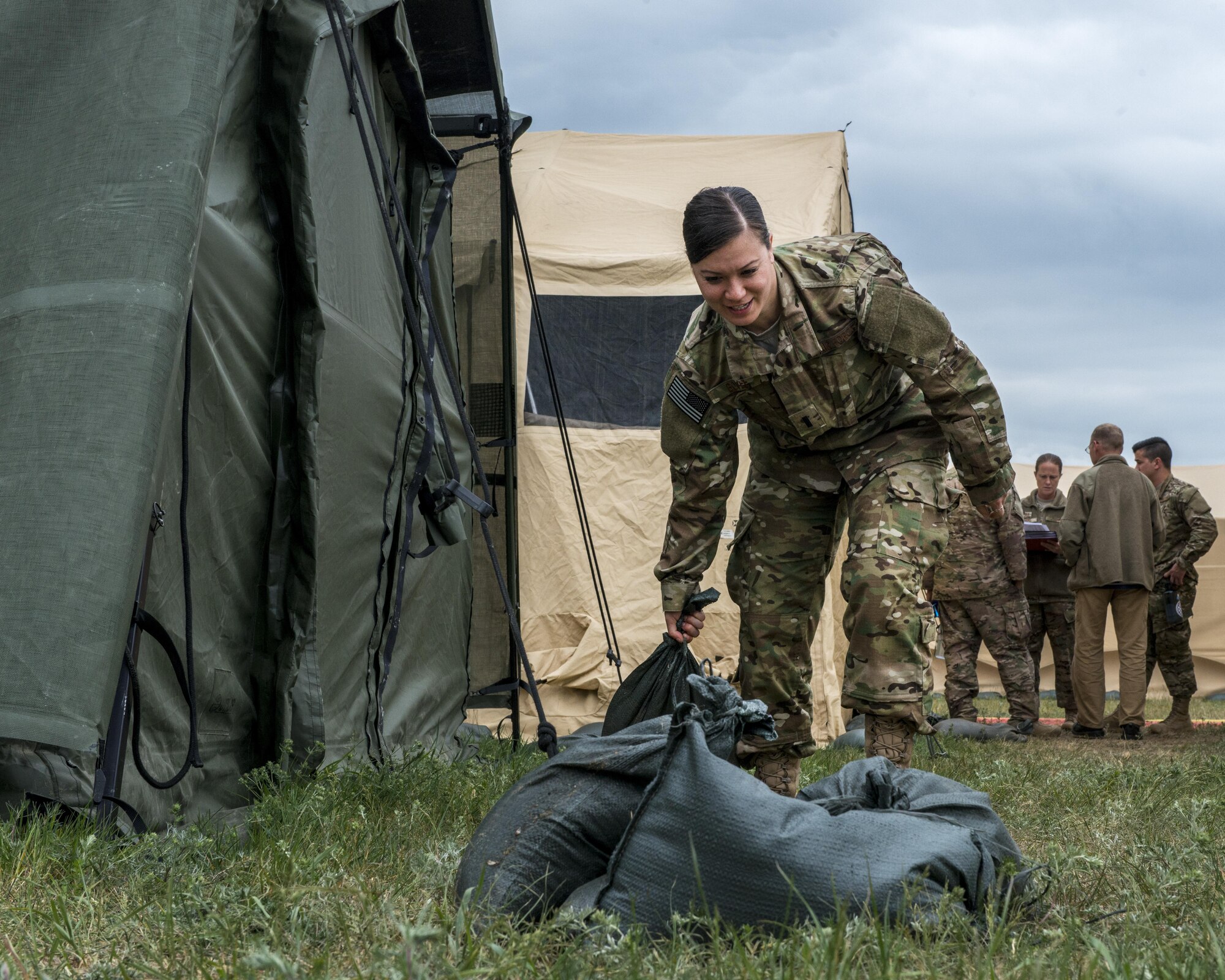 1st Lt. Christine Bovee, a communications officer assigned to the 352d Special Operations Support Squadron, moves sandbags while rerouting cabling in Powidz, Poland during TROJAN FOOTPRINT 16, May 18, 2016.  Approximately 200 aircrew, maintenance and support personnel deployed to Poland during TF16 to support MC-130J Commando II’s, CV-22 Ospreys and MH-47 Chinooks deployed for joint, combined training with NATO allies. (U.S. Air Force photo by 1st Lt. Chris Sullivan/Released)