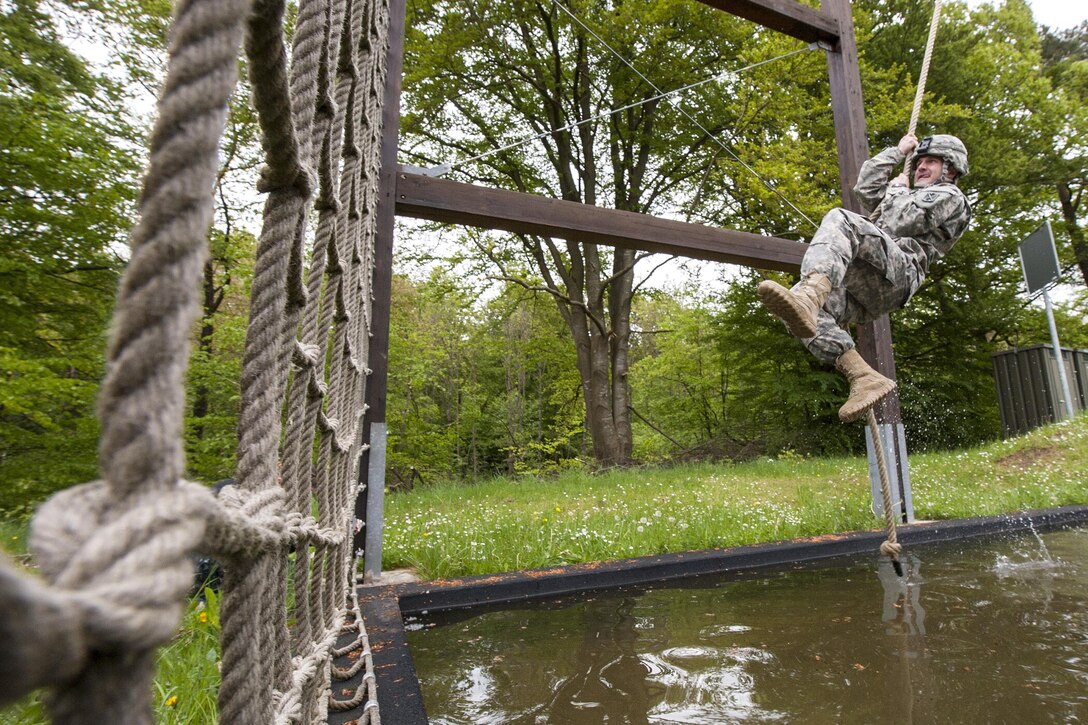 Army Sgt. Sean Salter swings on a rope across a water obstacle during the 10th Army Air and Missile Defense Command’s 2016 Best Warrior Competition in Baumholder, Germany, May 17, 2016. Air Force photo by Tech. Sgt. Brian Kimball