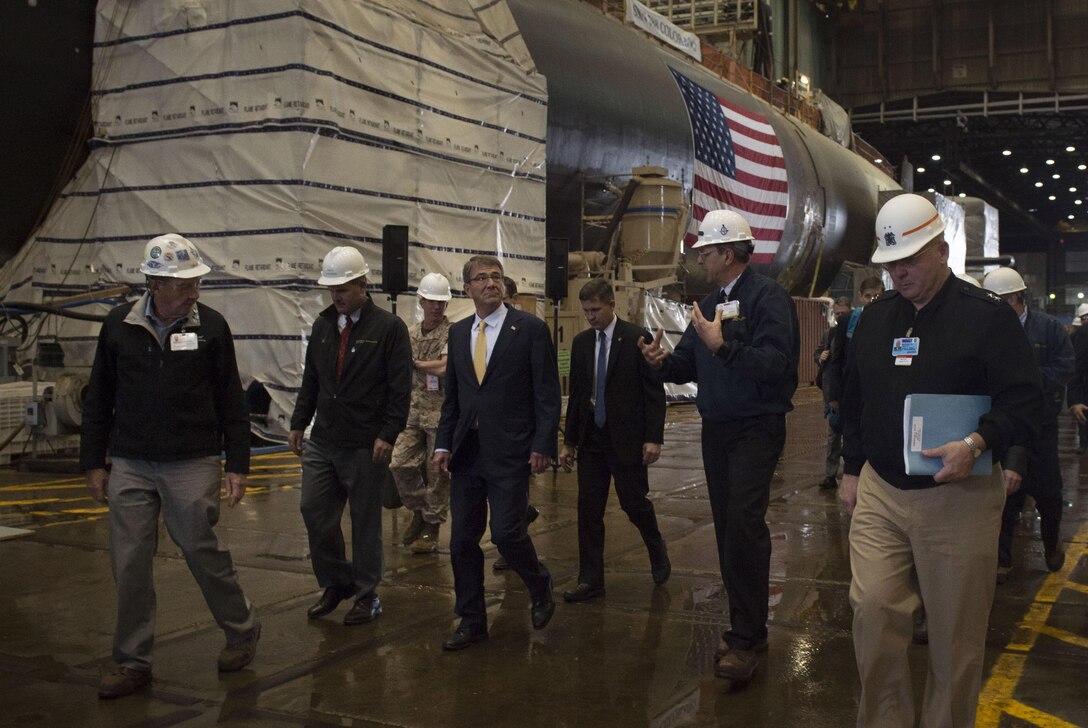 Defense Secretary Ash Carter walks with executives after arriving at an electric boat facility in Groton, Conn., May 24, 2016. Carter toured the facility during a three-day trip to New England to visit Navy installations and commission Air Force and Navy ROTC students at Yale University. DoD photo by Air Force Senior Master Sgt. Adrian Cadiz
