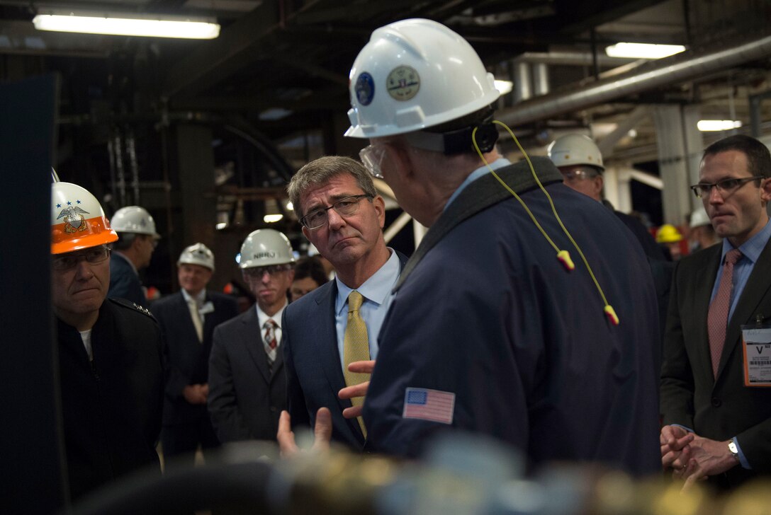 Defense Secretary Ash Carter speaks with an employee during a tour of an electric  boat facility in Groton, Conn., May 24, 2016. DoD photo by Air Force Senior Master Sgt. Adrian Cadiz