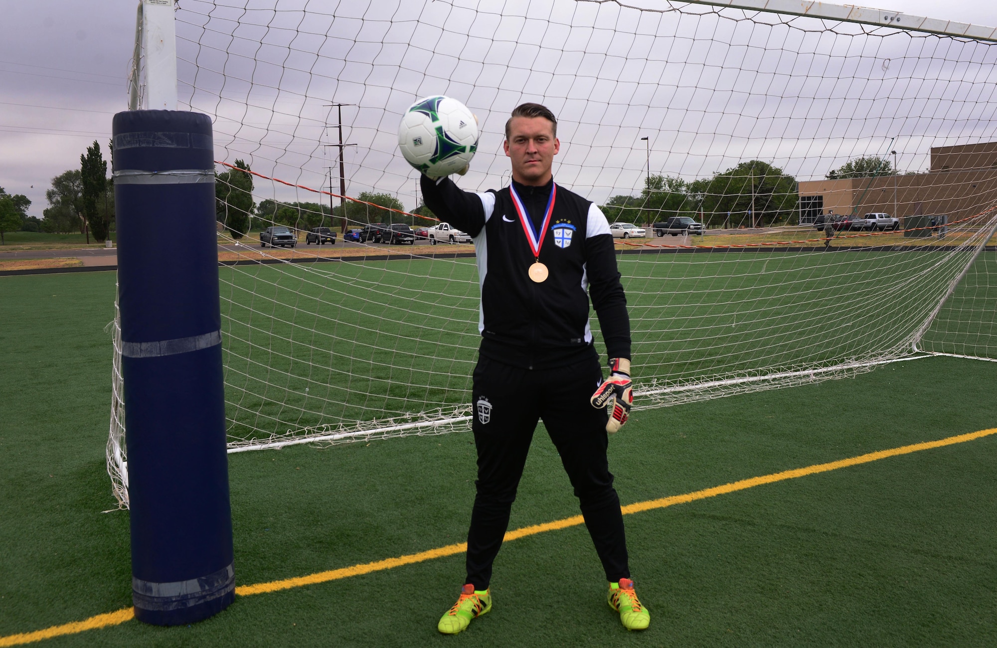 Senior Airman Kerry Segebart, 27th Special Operations Medical Support Squadron unit deployment manager, stands in his team uniform wearing a gold medal that came with a victory over the All-Armed Forces Championship tournament last month, May 19, 2016, at Cannon Air Force Base, N.M. Segebart attended an invitational soccer camp to make the Air Force team this past April, and was among the 18 selected for the team. (U.S. Air Force photo/Staff Sgt. Alexx Pons)