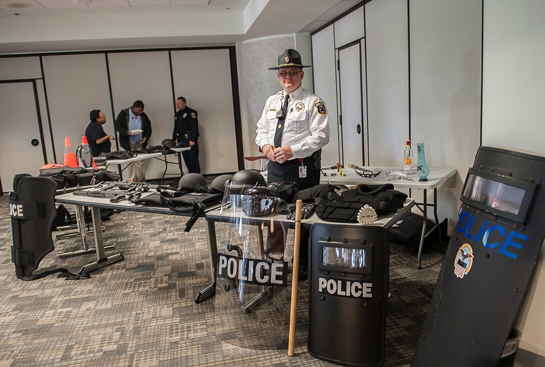 DLA Columbus Police Division Watch Commander Edward Compton Jr. stands behind a display of tactical police tools and equipment May 18. Also on display is a collection of contraband which police officers prevented from entering the installation. The displays are a part of week-long activities to celebrate Police Week.