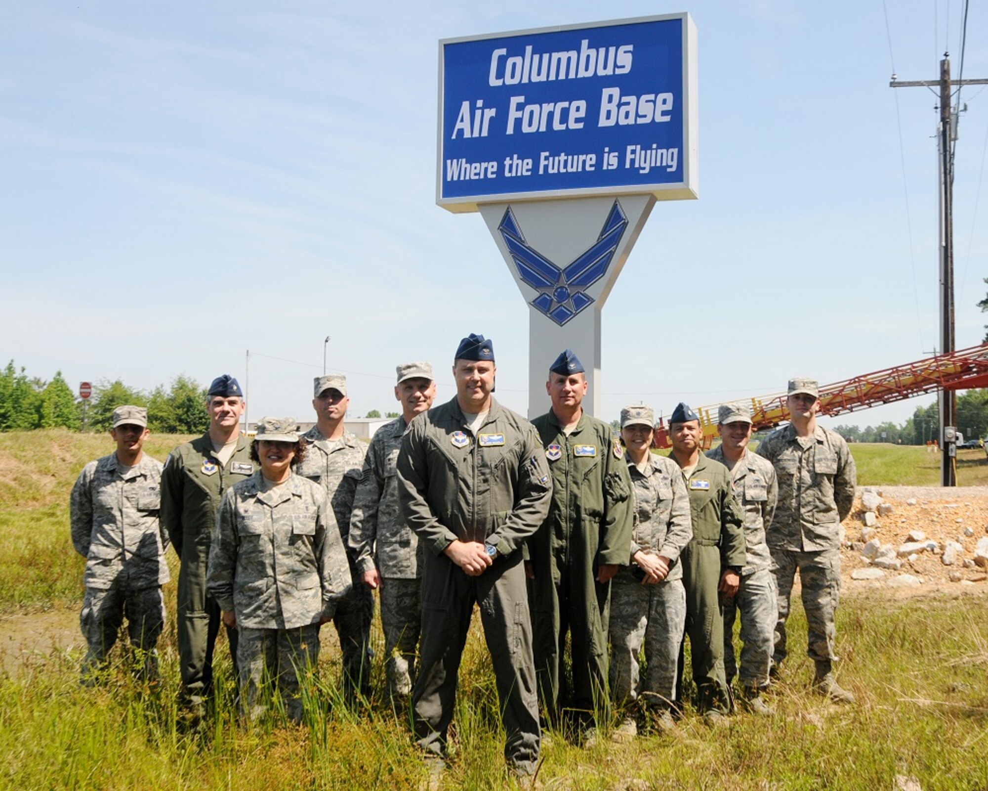 Col. John Nichols, 14th Flying Training Wing Commander, and other Columbus Air Force Base Airmen stand in front of the new base sign after a Chamber of Commerce-sponsored unveiling May 24 in Columbus, Mississippi. The new sign stands on Highway 45 marking the entrance to Columbus AFB and was paid for by donations from community members to modernize the 18-year-old sign. (U.S. Air Force photo/Melissa Doublin)
