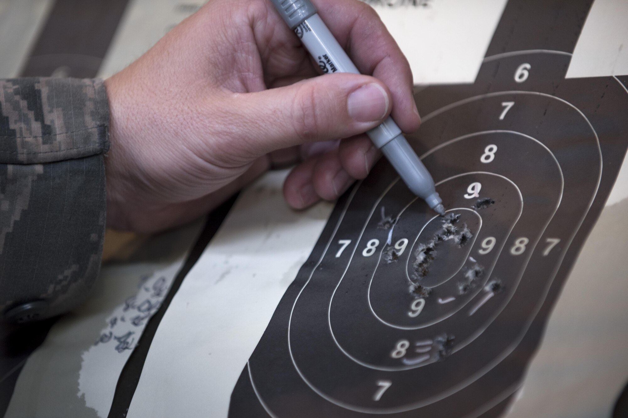 Tech. Sgt. Gregg Moseley, 11th Security Support Squadron combat arms training and maintenance instructor, marks shots during the 2016 Elementary Level Excellence in Competition Rifle Match at Joint Base Andrews, Md., May 17. The top ten percent of competitors in the EIC receive a uniform badge. (U.S. Air Force photo by Airman 1st Class Philip Bryant) 