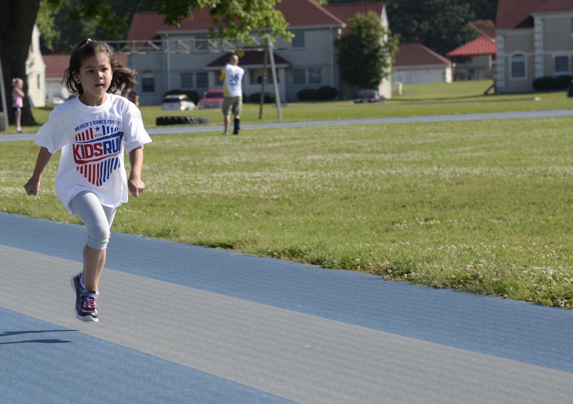 The daughter of Master Sergeant Marie Brown, 2nd Bomb Wing Public Affairs, completes her first lap during the Armed Forces Kids’ Run at Barksdale Air Force Base, La., May 21, 2016. Children ages 5-6 ran half a mile, 7-8 ran a mile and 9-14 ran two miles for the event. (U.S. Air Force photo/Airman 1st Class Stuart Bright)