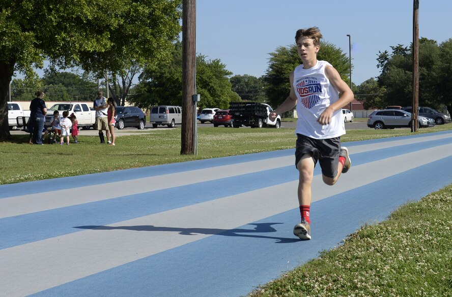 A runner leads the two-mile race during the Armed Forces Kids’ Run at Barksdale Air Force Base, La., May 21, 2016. Children ages 5-14 were welcome to participate in the free event. (U.S. Air Force photo/Airman 1st Class Stuart Bright)