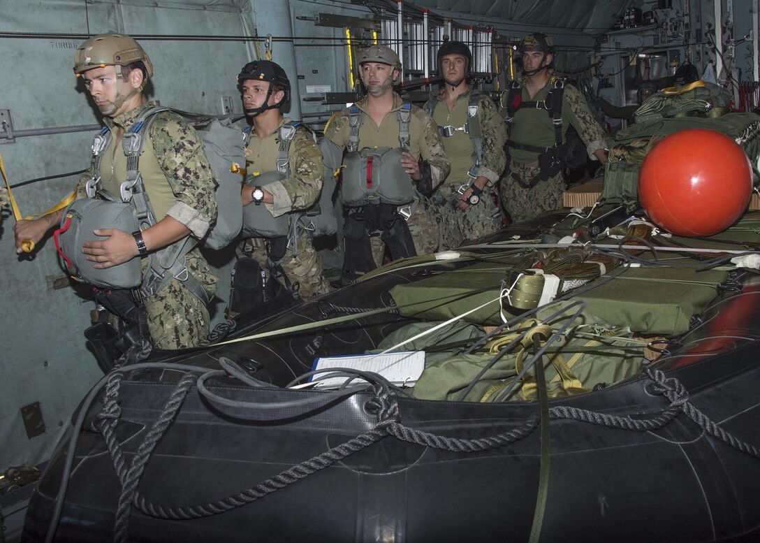 Sailors aboard a C-130 Hercules aircraft wait for the signal to jump before participating in a combat rubber raiding craft insertion off the coast of Guam during exercise Tricrab, May 18, 2016. Navy photo by Petty Officer 1st Class Doug Harvey