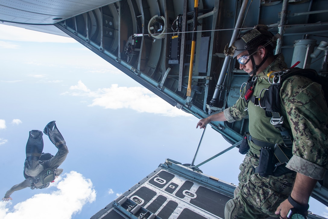 A sailor performs a free fall jump from a C-130 Hercules aircraft during exercise Tricrab off the coast of Guam, May 18, 2016. Navy photo by Petty Officer 1st Class Doug Harvey