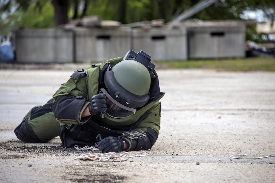 A Canadian explosive ordnance disposal technician prepares to inspect an improvised explosive device during a training scenario as part of exercise Tricrab at Naval Base Guam, May 18, 2016. Navy photo by Petty Officer 3rd Class Alfred A. Coffield