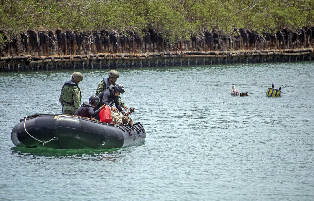 Singapore explosive ordnance disposal technicians participate in a limpet mine training operation during exercise Tricrab at Naval Base Guam, May 18, 2016. Navy photo by Petty Officer 3rd Class Alfred A. Coffield
