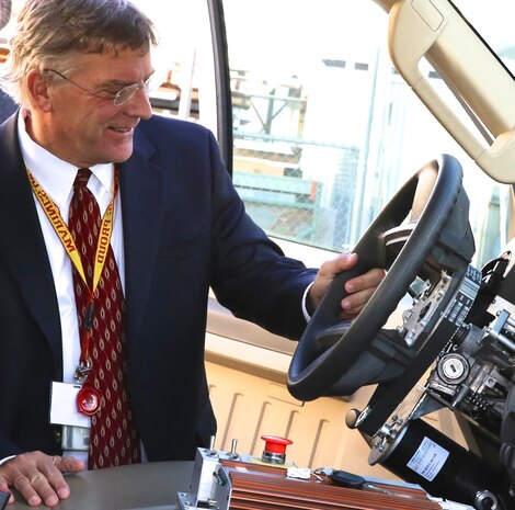 China Lake, Calif. - Dr. John Burrow gets behind the wheel of a driverless, Ford F-350 truck with software integrated by the Applied Manufacturing Technology Department at Naval Air Warfare Center Weapons Division China Lake. The department helps modify the trucks to pull targets during weapons testing. "Additive manufacturing will fundamentally change how we think, how we do business, the cost variable, and how we make decisions," Burrow - Deputy Assistant Secretary of the Navy for Research, Development, Test and Evaluation - told 3D Printing exhibitors and visitors at the Navy Additive Manufacturing Showcase April 20, 2016. "I think you are about to see its operational and technical potential literally explode off the map." 