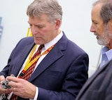 China Lake, Calif. - Executive Director Scott O' Neil, right, hands a component to Dr. John Burrow to take a closer look at the intricate parts that are assembled and manufactured in-house at Naval Air Warfare Center Weapons Division China Lake. "Additive manufacturing will fundamentally change how we think, how we do business, the cost variable, and how we make decisions," Burrow - Deputy Assistant Secretary of the Navy for Research, Development, Test and Evaluation - told 3D Printing exhibitors and visitors at the Navy Additive Manufacturing Showcase April 20, 2016. "I think you are about to see its operational and technical potential literally explode off the map." Burrow sponsored the event to explore innovative applications of additive manufacturing that benefit the warfighter and to highlight its impact throughout program lifecycles from early concepts, into component and system testing, and sustainment. 
