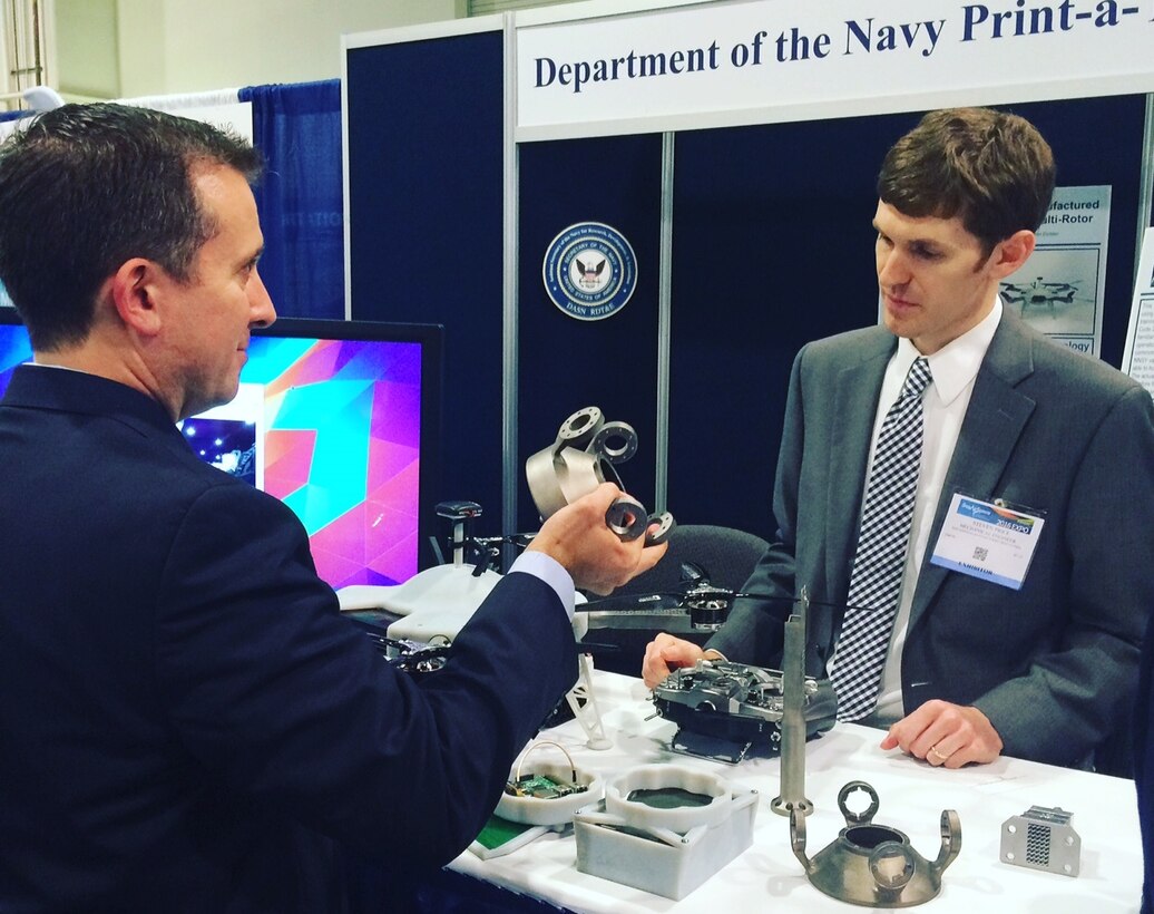 NATIONAL HARBOR, Md. (May 17, 2016) - Navy engineer Steve Price answers an attendee's question about the small additively manufactured modular payload multi-rotor at the 2016 Sea-Air-Space Expo. This low cost, 3D printed, unmanned aerial vehicle is rapidly adaptable to mission requirements and can accept a wide variety of custom payloads. The UAV was one of the exhibits featured at the Navy Additive Manufacturing Showcase in Dahlgren, Va., last month that were selected for display at the Sea-Air-Space Expo. "The volume of creative and innovative ideas made feasible with 3D Printing is astounding," said Lynn Shoppell, a Naval Surface Warfare Center Dahlgren Division physicist after the Dahlgren showcase. "The exhibitors demonstrated that their concepts for increased technical capabilities, rapid prototyping, improved logistics operations, and cost reduction initiatives are achievable with 3D Printing. Participants also experimented with additive manufacturing technology research and development."  