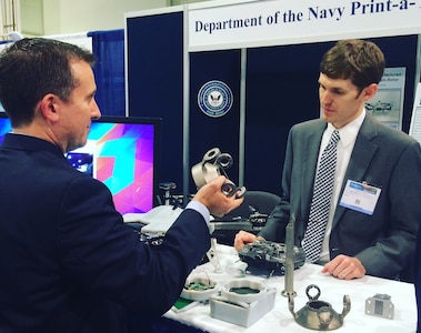 NATIONAL HARBOR, Md. (May 17, 2016) - Navy engineer Steve Price answers an attendee's question about the small additively manufactured modular payload multi-rotor at the 2016 Sea-Air-Space Expo. This low cost, 3D printed, unmanned aerial vehicle is rapidly adaptable to mission requirements and can accept a wide variety of custom payloads. The UAV was one of the exhibits featured at the Navy Additive Manufacturing Showcase in Dahlgren, Va., last month that were selected for display at the Sea-Air-Space Expo. "The volume of creative and innovative ideas made feasible with 3D Printing is astounding," said Lynn Shoppell, a Naval Surface Warfare Center Dahlgren Division physicist after the Dahlgren showcase. "The exhibitors demonstrated that their concepts for increased technical capabilities, rapid prototyping, improved logistics operations, and cost reduction initiatives are achievable with 3D Printing. Participants also experimented with additive manufacturing technology research and development."  