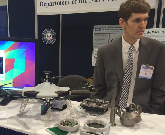 NATIONAL HARBOR, Md. (May 17, 2016) - Navy engineer Steve Price briefs 2016 Sea-Air-Space Expo attendees on the small additively manufactured modular payload multi-rotor. This low cost, 3D printed, unmanned aerial vehicle can accept a wide variety of custom payloads. The UAV was one of the exhibits featured at the Navy Additive Manufacturing Showcase in Dahlgren, Va., last month that were selected for display at the Sea-Air-Space Expo. "The volume of creative and innovative ideas made feasible with 3D Printing is astounding," said Lynn Shoppell, a Naval Surface Warfare Center Dahlgren Division physicist after the Dahlgren showcase. "The exhibitors demonstrated that their concepts for increased technical capabilities, rapid prototyping, improved logistics operations, and cost reduction initiatives are achievable with 3D Printing. Participants also experimented with additive manufacturing technology research and development."