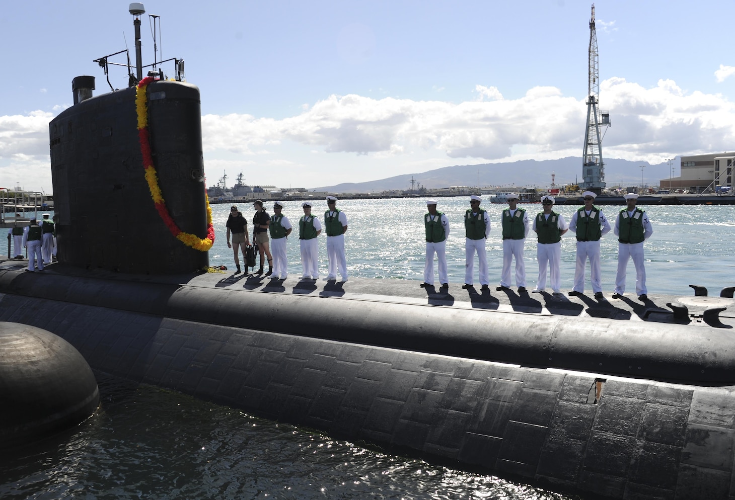 U.S. Sailors stand topside aboard the Los Angeles-class fast-attack submarine USS Tucson (SSN 770) as the ship moors in Pearl Harbor, Hawaii, after the successful completion of a regularly scheduled Western Pacific deployment May 24, 2016. (U.S. Navy photo by Mass Communication Specialist 2nd Class Shaun Griffin)