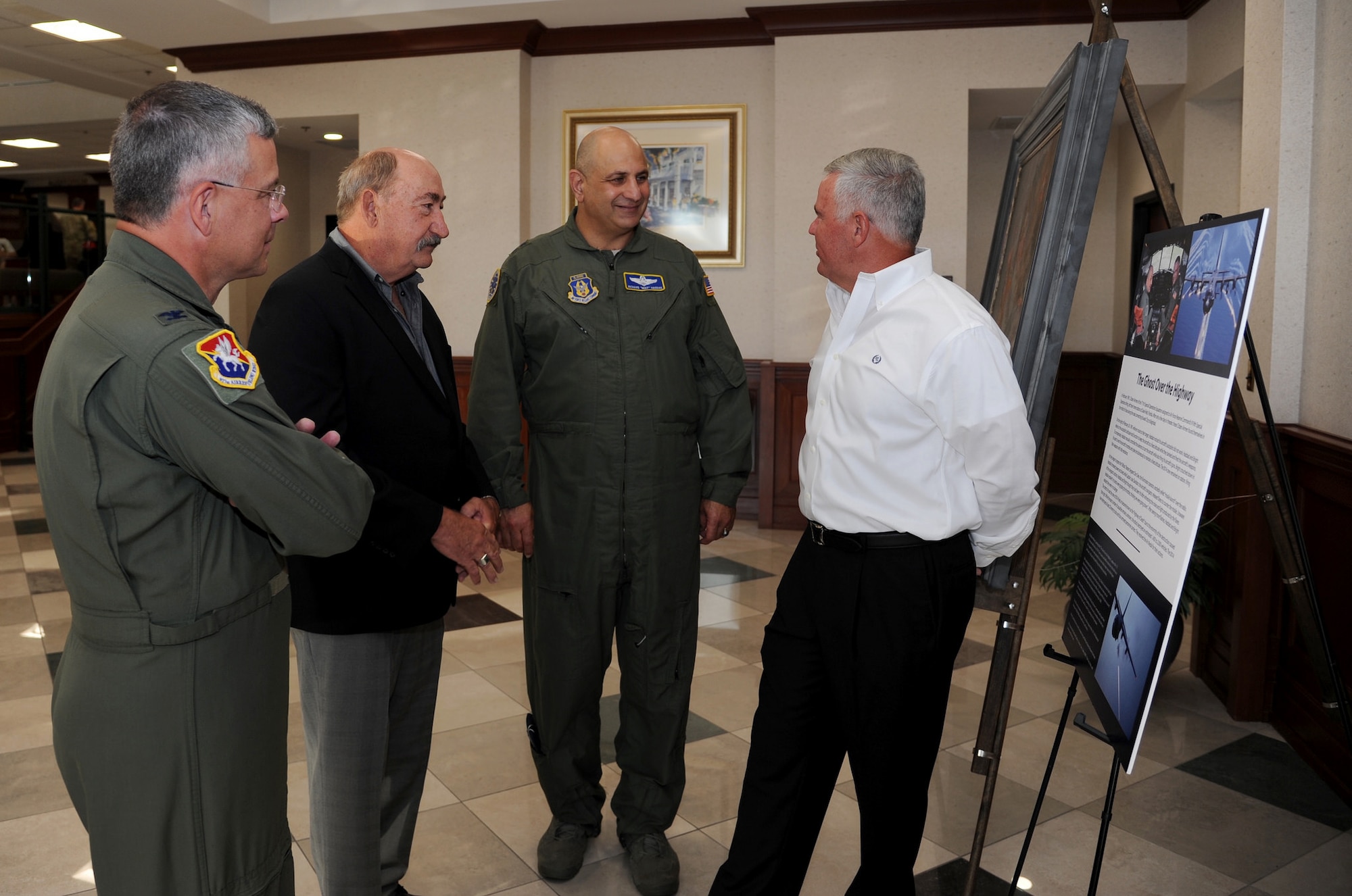 Retired Col. Jose Davison recounts details of the mission featured by the “Ghost on the Highway” painting with Maj. Gen. Richard “Beef” Haddad, vice commander of the Air Force Reserve Command, retired Master Sgt. Larry Ridge and Col. Randal Bright, 927th Air Refueling Wing commander. All were members of the Reserve’s 711th Special Operations Squadron, a subordinate unit of the 919th Special Operations Wing, Duke Field, Florida, during Desert Storm. (U.S. Air Force photo/Tech. Sgt. Peter Dean)