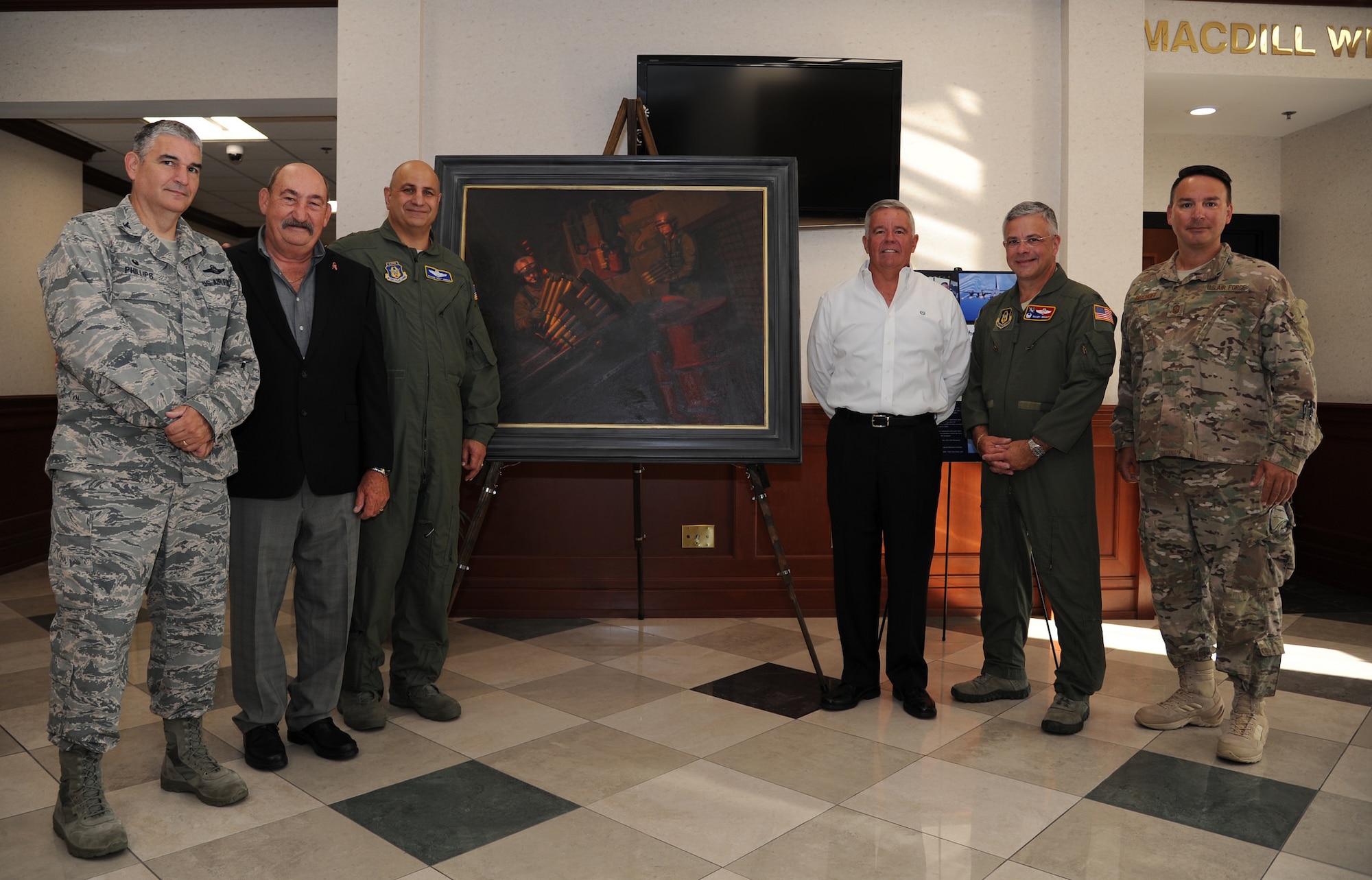 Current and past members of the 919th Special Operations Wing stand beside the newly unveiled painting “Ghost on the Highway” by Maj. Warren Neary during a ceremony May 23 at MacDill Air Force Base, Fla.  The painting marked the 25th anniversary of Operation Desert Storm and was unveiled with Gen. Raymond Thomas, commander of U.S. Special Operations Command, during the Retired Special Operations Senior Leader Conference.  (U.S. Air Force photo/Tech. Sgt. Peter Dean)