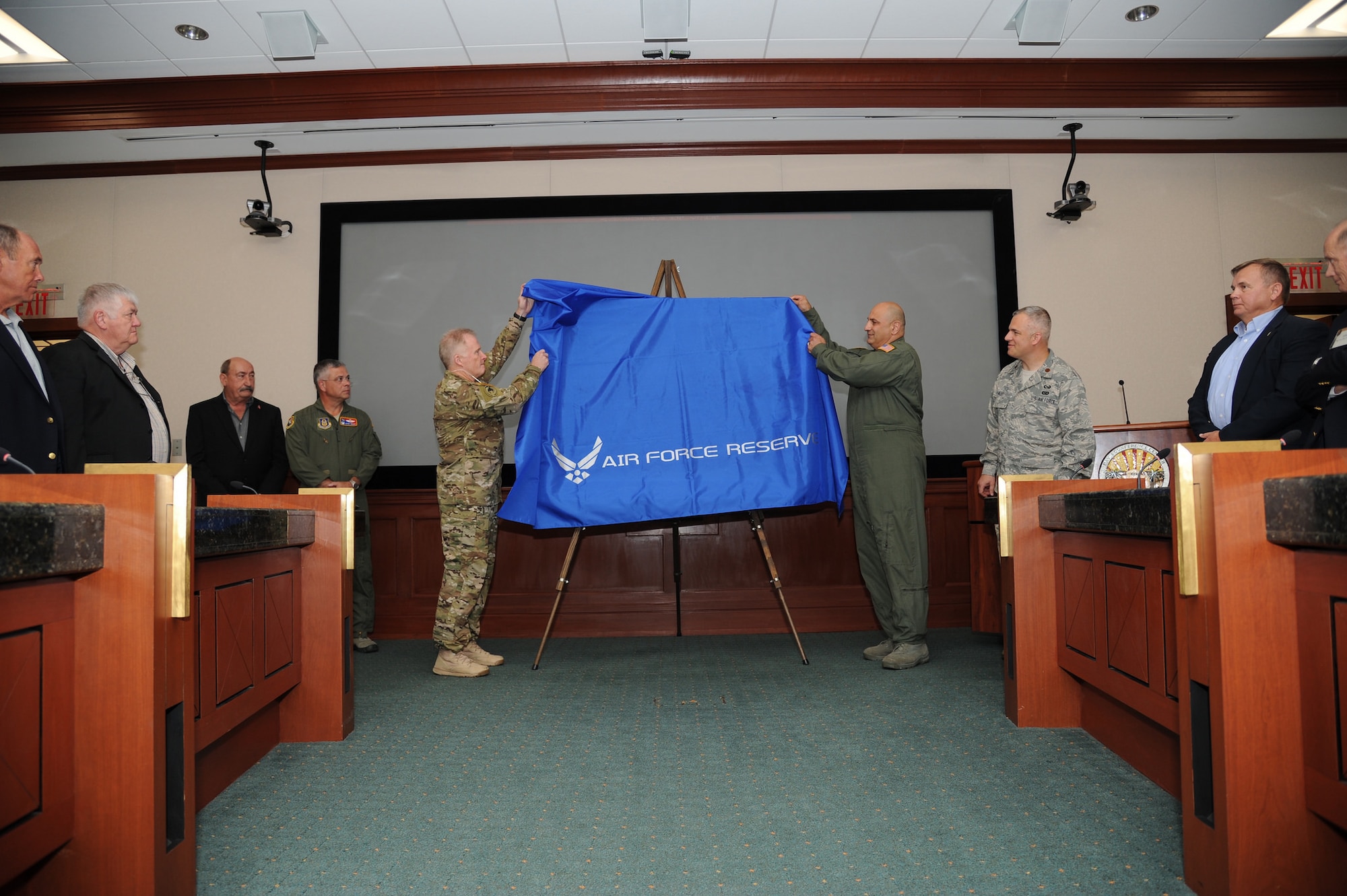 Gen. Raymond Thomas III, commander of U.S. Special Operations Command, left, and Maj. Gen. Richard “Beef” Haddad, vice commander of the Air Force Reserve Command, unveil a painting “Ghost on the Highway” by Maj. Warren Neary during a ceremony May 23, 2016, at MacDill Air Force Base, Fla. The event marked the 25th anniversary of Operation Desert Storm during the Retired Special Operations Senior Leader Conference.  (U.S. Air Force photo/Tech. Sgt. Peter Dean)