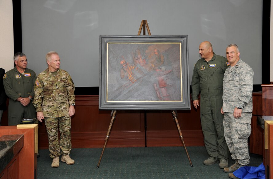 Gen. Raymond Thomas III, commander of U.S. Special Operations Command, left, and Maj. Gen. Richard “Beef” Haddad, vice commander of the Air Force Reserve Command, admire a painting they unveiled moments earlier titled “Ghost on the Highway” by Maj. Warren Neary during a ceremony May 23 at MacDill Air Force Base, Fla.  Flanking them are Col. Randal Bright, 927th Air Refueling Wing commander, left, and Neary. The event marked the 25th anniversary of Operation Desert Storm during the Retired Special Operations Senior Leader Conference.  (U.S. Air Force photo/Tech. Sgt. Peter Dean)